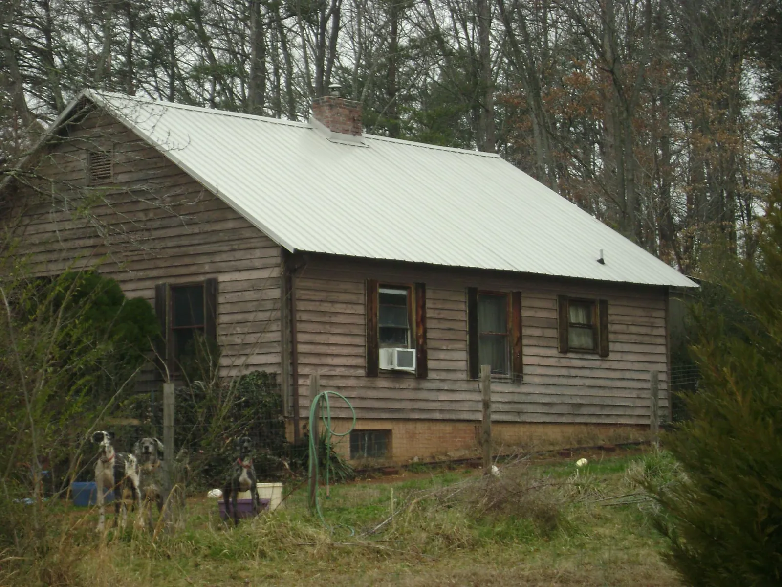White metal roof on an old wood sided farmhouse, from a Metal Roof Installation job in Coffeyville